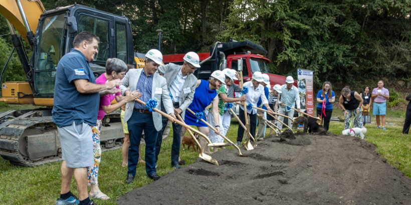many people shoveling earth