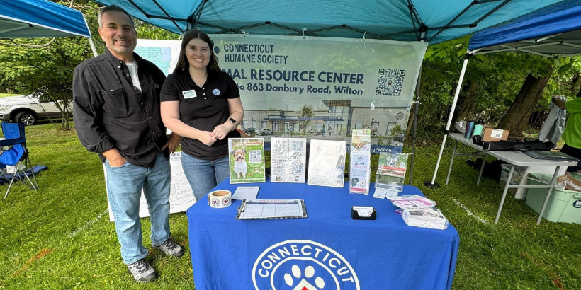 two people standing in front of banner